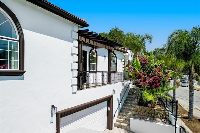 1935 Wollam St, Los Angeles, CA 90065 - view of side of property with stucco siding, a garage, and a pergola