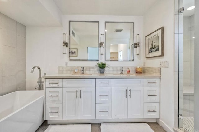 295 Chinquapin Ave, Carlsbad, CA 92008 - full bathroom featuring a freestanding tub, double vanity, a stall shower, and tasteful backsplash
