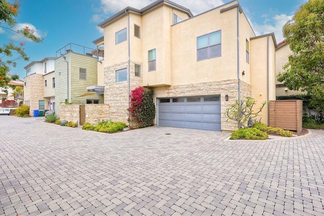 295 Chinquapin Ave, Carlsbad, CA 92008 - view of front facade with stone siding, a garage, decorative driveway, and stucco siding