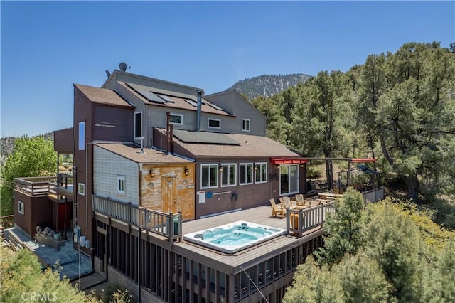 1903 Dusk Pl, Pine Mountain Club, CA 93225 - rear view of property featuring a wooden deck, solar panels, and a forest view