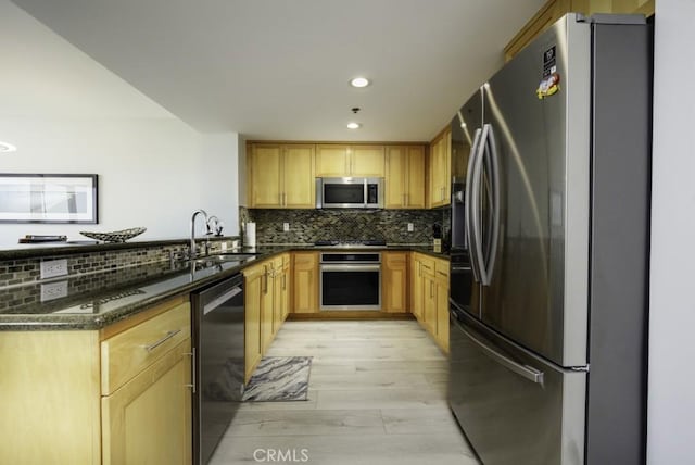 411 W Seaside Way Unit 1103, Long Beach, CA 90802 - kitchen with appliances with stainless steel finishes, light wood-type flooring, tasteful backsplash, a sink, and recessed lighting