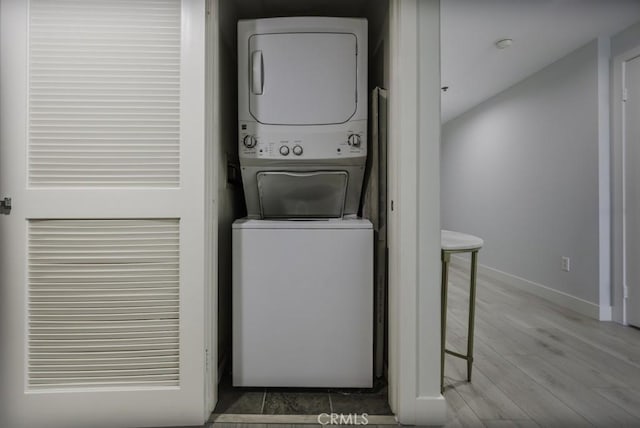411 W Seaside Way Unit 1103, Long Beach, CA 90802 - laundry area with stacked washer / dryer, baseboards, and wood finished floors