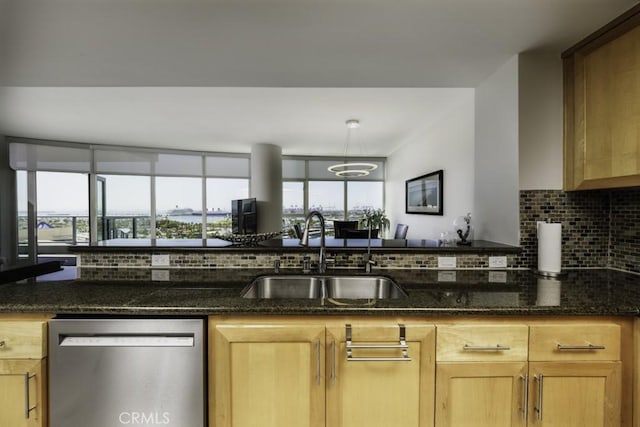 411 W Seaside Way Unit 1103, Long Beach, CA 90802 - kitchen with stainless steel dishwasher, a sink, backsplash, dark stone counters, and light brown cabinets