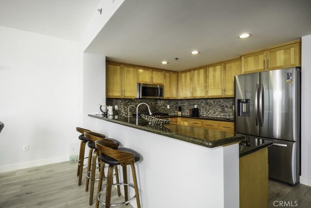 411 W Seaside Way Unit 1103, Long Beach, CA 90802 - kitchen featuring stainless steel appliances, baseboards, decorative backsplash, and recessed lighting