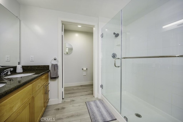 411 W Seaside Way Unit 1103, Long Beach, CA 90802 - bathroom with a shower stall, vanity, wood finished floors, and baseboards