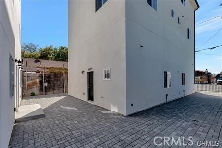 8418 S Main St, Los Angeles, CA 90003 - view of home's exterior featuring stucco siding and a patio