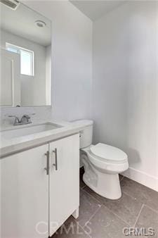 8418 S Main St, Los Angeles, CA 90003 - bathroom with vanity, toilet, baseboards, and tile patterned floors