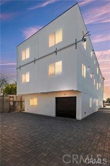 8418 S Main St, Los Angeles, CA 90003 - view of side of home featuring stucco siding and an attached garage