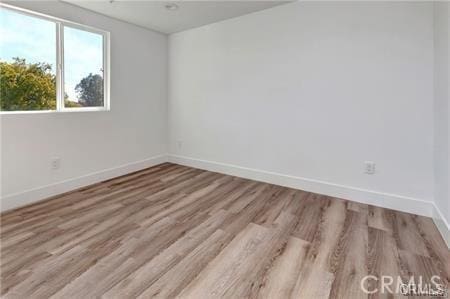 8418 S Main St, Los Angeles, CA 90003 - empty room featuring baseboards and wood finished floors