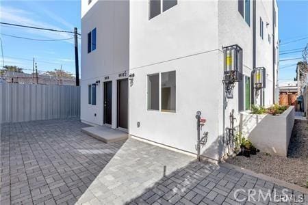 8418 S Main St, Los Angeles, CA 90003 - back of property with stucco siding and a patio area