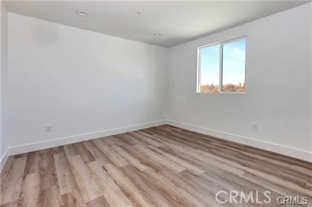 8418 S Main St, Los Angeles, CA 90003 - empty room featuring wood finished floors and baseboards