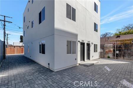 8418 S Main St, Los Angeles, CA 90003 - rear view of property featuring stucco siding and a patio area