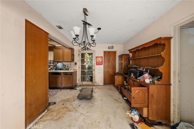 13397 Robin Ct, Yucaipa, CA 92399 - kitchen featuring brown cabinetry, a chandelier, and a textured ceiling