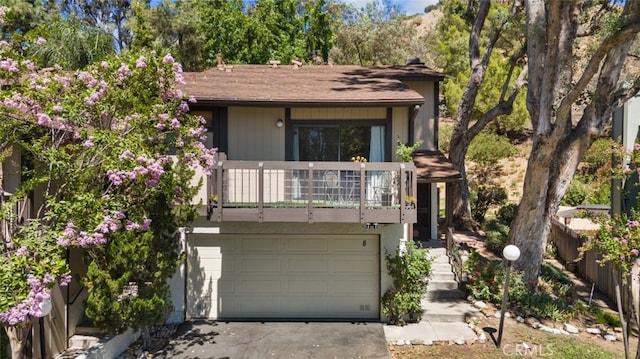 10831 Roycroft St Unit 8, Sun Valley, CA 91352 - view of front of property with a garage, asphalt driveway, a balcony, and a shingled roof