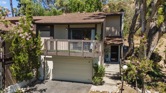 10831 Roycroft St Unit 8, Sun Valley, CA 91352 - view of front facade with a balcony, an attached garage, asphalt driveway, and roof with shingles