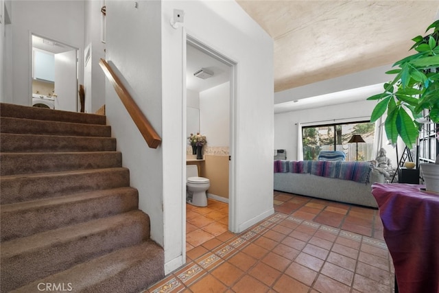 10831 Roycroft St Unit 8, Sun Valley, CA 91352 - staircase featuring washer / clothes dryer, tile patterned flooring, and baseboards