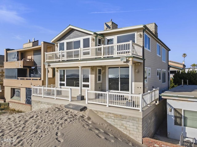 4177 Ocean Dr, Oxnard, CA 93035 - view of front facade featuring a balcony and a chimney