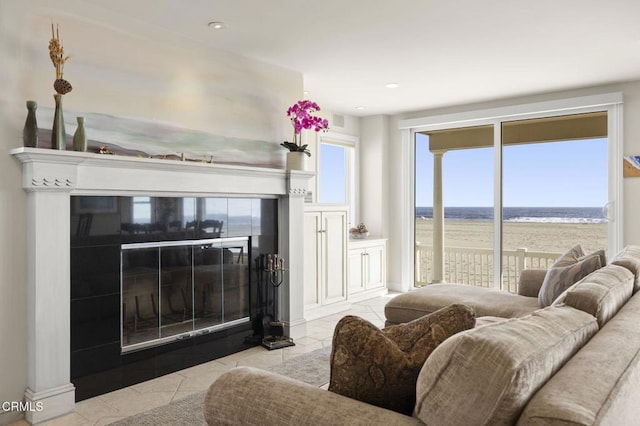 4177 Ocean Dr, Oxnard, CA 93035 - living room with light tile patterned flooring, recessed lighting, a fireplace, and a water view