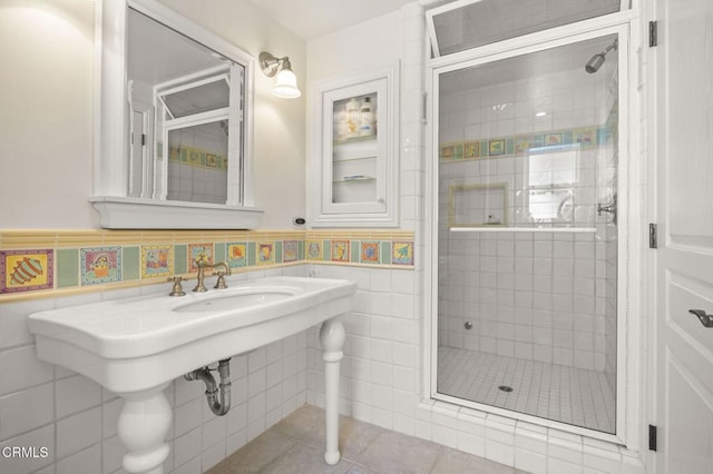 4177 Ocean Dr, Oxnard, CA 93035 - full bath featuring a stall shower, tile walls, tile patterned flooring, and a wainscoted wall