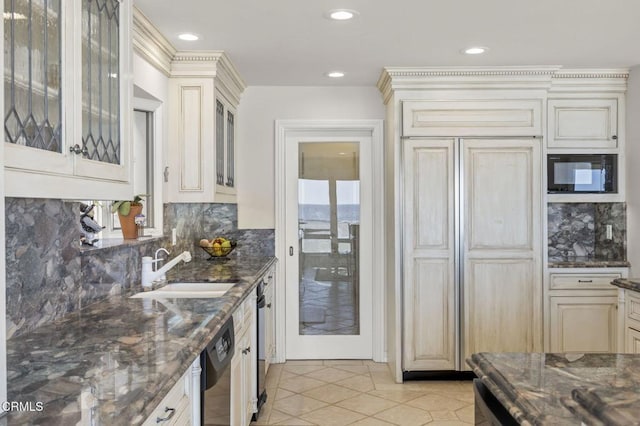 4177 Ocean Dr, Oxnard, CA 93035 - kitchen with a sink, dishwasher, cream cabinets, black microwave, and dark stone countertops