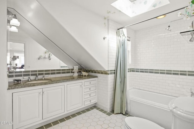 4177 Ocean Dr, Oxnard, CA 93035 - full bathroom with toilet, tile patterned flooring, tile walls, shower / bathtub combination with curtain, and vanity