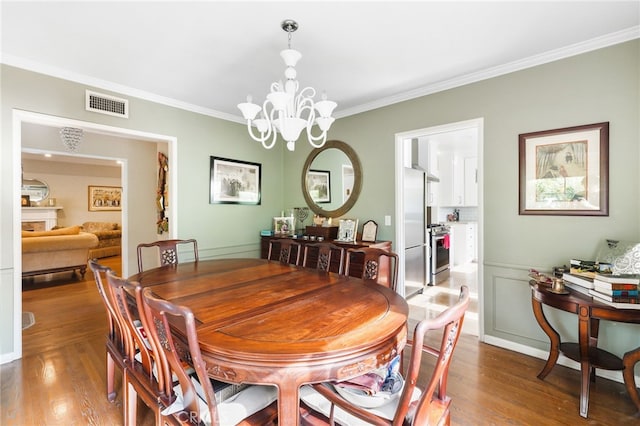 14060 Chandler Blvd, Sherman Oaks, CA 91401 - dining room featuring ornamental molding, wood finished floors, and a chandelier