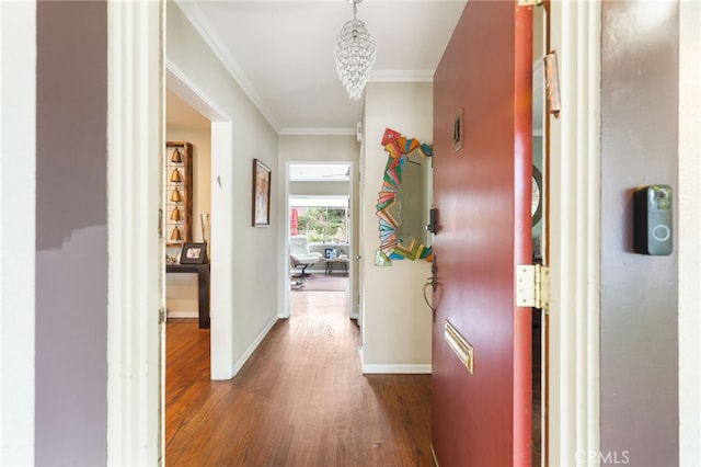 14060 Chandler Blvd, Sherman Oaks, CA 91401 - hallway featuring wood finished floors, crown molding, baseboards, and a chandelier