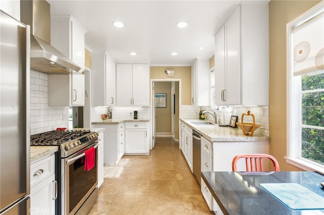 14060 Chandler Blvd, Sherman Oaks, CA 91401 - kitchen featuring wall chimney exhaust hood, stainless steel appliances, white cabinetry, tasteful backsplash, and recessed lighting