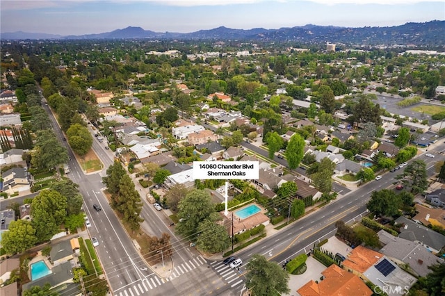 14060 Chandler Blvd, Sherman Oaks, CA 91401 - aerial overview of property's location featuring a mountain backdrop, a pool area, and nearby suburban area