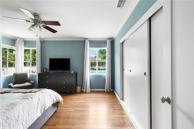 14060 Chandler Blvd, Sherman Oaks, CA 91401 - bedroom featuring multiple windows, light wood finished floors, a ceiling fan, baseboards, and ornamental molding