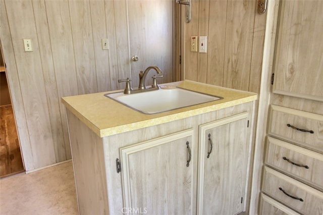 2843 E Westfall Rd, Mariposa, CA 95338 - kitchen featuring a sink, wooden walls, light brown cabinets, and light countertops