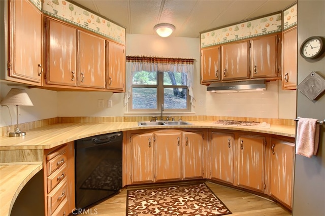 2843 E Westfall Rd, Mariposa, CA 95338 - kitchen with dishwasher, a sink, under cabinet range hood, light wood-style floors, and white gas cooktop