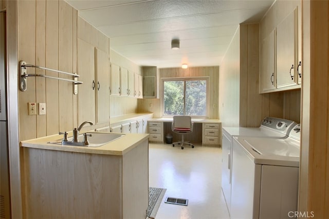 2843 E Westfall Rd, Mariposa, CA 95338 - washroom featuring separate washer and dryer, cabinet space, a desk, and wooden walls