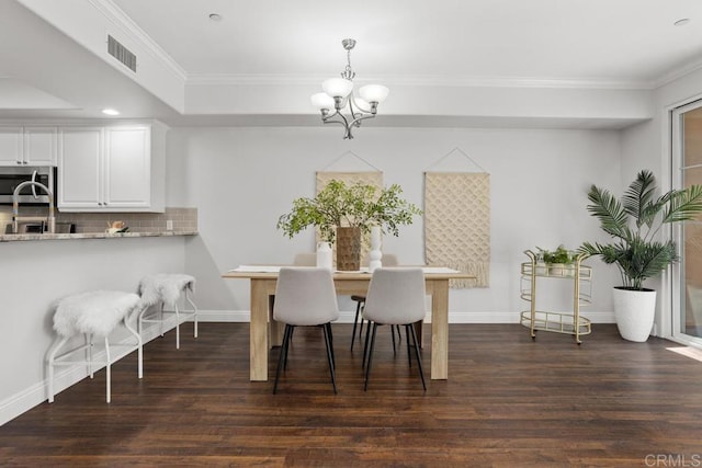 2778 Carlsbad Blvd Unit 201, Carlsbad, CA 92008 - dining space with a chandelier, ornamental molding, dark wood finished floors, and baseboards