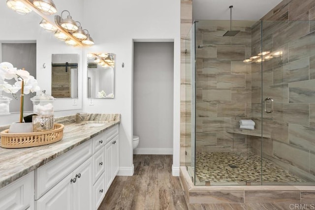 2778 Carlsbad Blvd Unit 201, Carlsbad, CA 92008 - full bath featuring vanity, a shower stall, toilet, wood finished floors, and baseboards