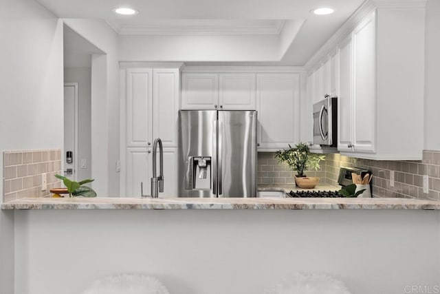 2778 Carlsbad Blvd Unit 201, Carlsbad, CA 92008 - kitchen with appliances with stainless steel finishes, decorative backsplash, white cabinets, crown molding, and recessed lighting