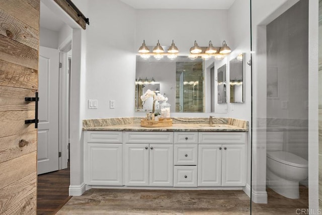 2778 Carlsbad Blvd Unit 201, Carlsbad, CA 92008 - full bathroom featuring vanity, wood finished floors, toilet, and a shower