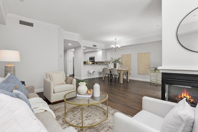 2778 Carlsbad Blvd Unit 201, Carlsbad, CA 92008 - living area featuring a chandelier, ornamental molding, wood finished floors, baseboards, and a multi sided fireplace