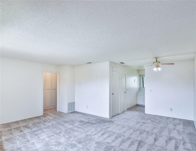 345 W 41st St, San Bernardino, CA 92407 - carpeted empty room with a textured ceiling and ceiling fan