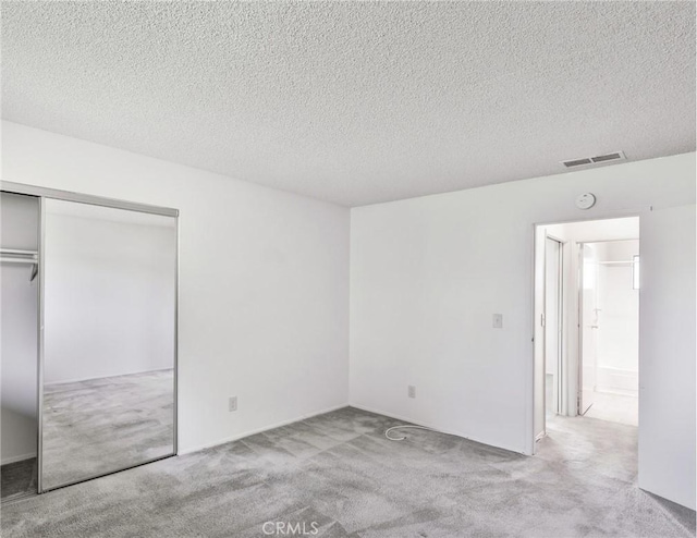 345 W 41st St, San Bernardino, CA 92407 - unfurnished bedroom featuring carpet, a textured ceiling, and a closet