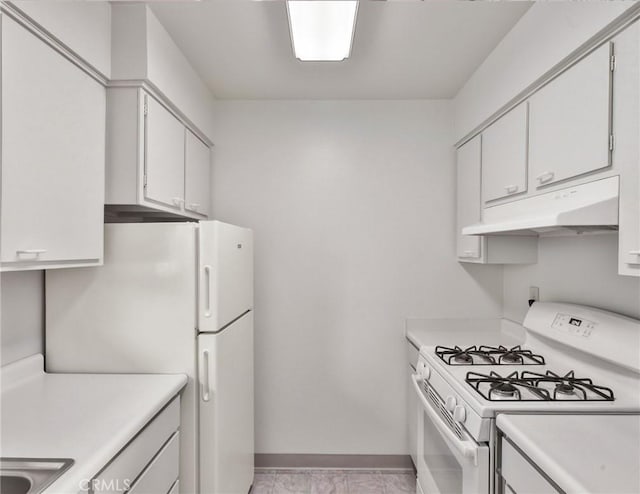 345 W 41st St, San Bernardino, CA 92407 - kitchen featuring white appliances, under cabinet range hood, light countertops, baseboards, and white cabinetry