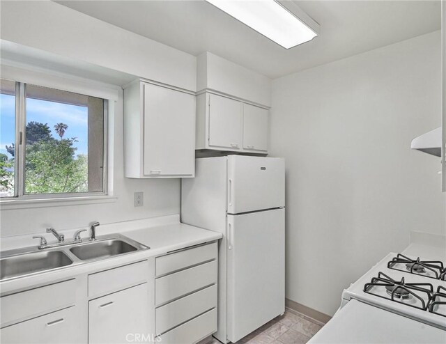 345 W 41st St, San Bernardino, CA 92407 - kitchen with a sink, freestanding refrigerator, white cabinetry, light countertops, and ventilation hood