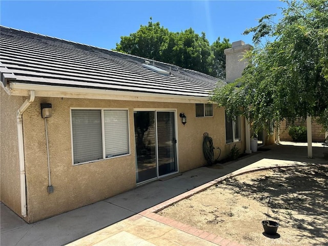 1715 Lake Way, Lancaster, CA 93534 - back of house with stucco siding, a patio, and a chimney
