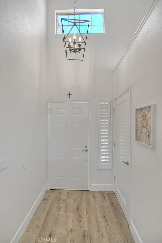 2693 Lookout Cir, Chino Hills, CA 91709 - foyer entrance featuring light wood finished floors, a chandelier, and baseboards