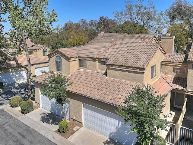 2693 Lookout Cir, Chino Hills, CA 91709 - view of front facade featuring a tiled roof, stucco siding, concrete driveway, and a garage