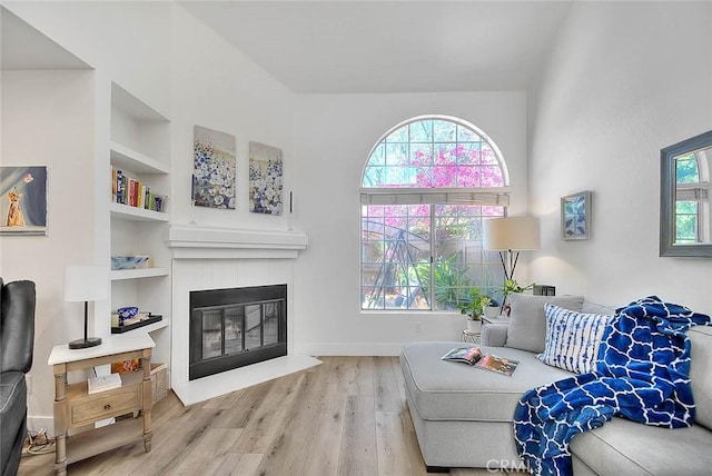 2693 Lookout Cir, Chino Hills, CA 91709 - living area featuring built in features, wood finished floors, a tile fireplace, and baseboards