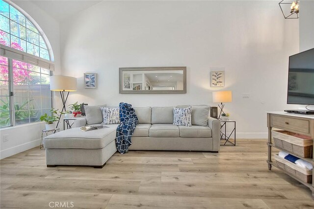 2693 Lookout Cir, Chino Hills, CA 91709 - living room featuring baseboards, healthy amount of natural light, wood finished floors, and a high ceiling