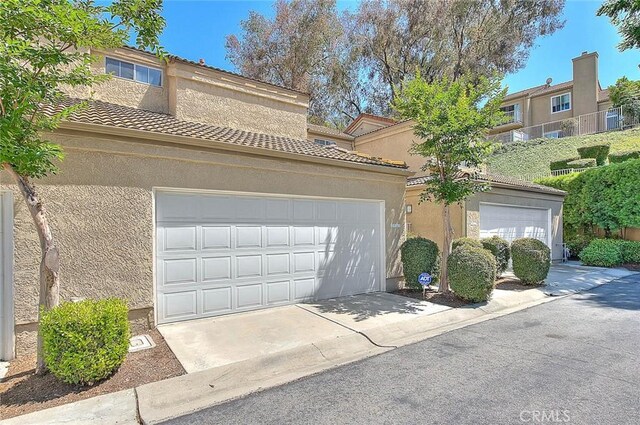 2693 Lookout Cir, Chino Hills, CA 91709 - view of front of home featuring stucco siding, a tile roof, and driveway