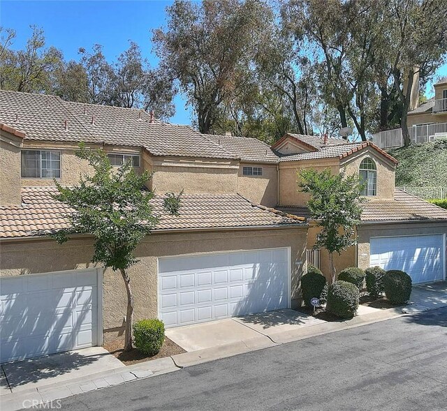 2693 Lookout Cir, Chino Hills, CA 91709 - traditional-style home with a tile roof, stucco siding, a garage, and driveway