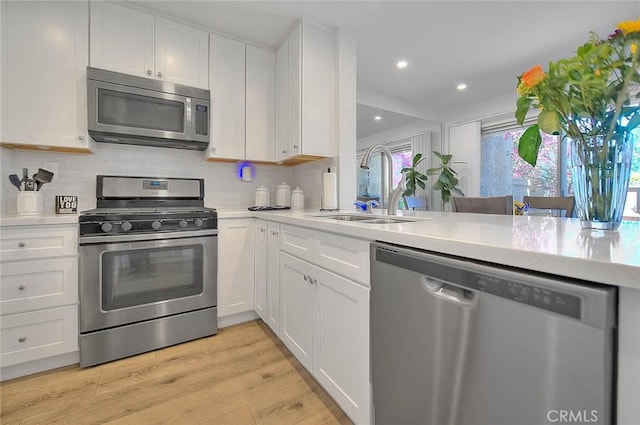 2693 Lookout Cir, Chino Hills, CA 91709 - kitchen with appliances with stainless steel finishes, a sink, light countertops, white cabinetry, and recessed lighting